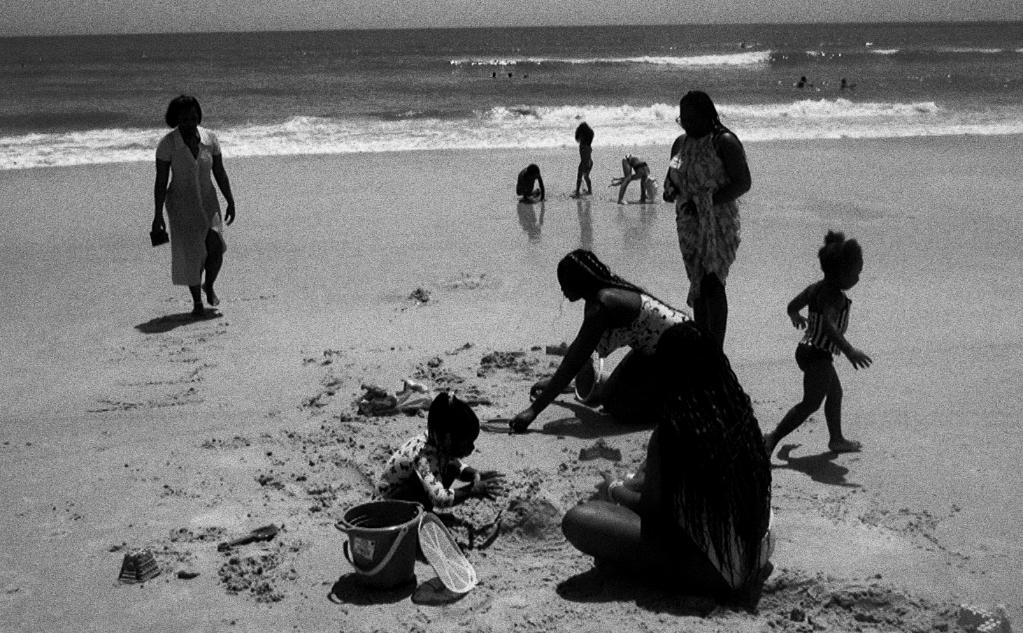 Parents and children playing on a sunny beach